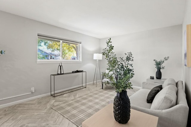 living area featuring baseboards