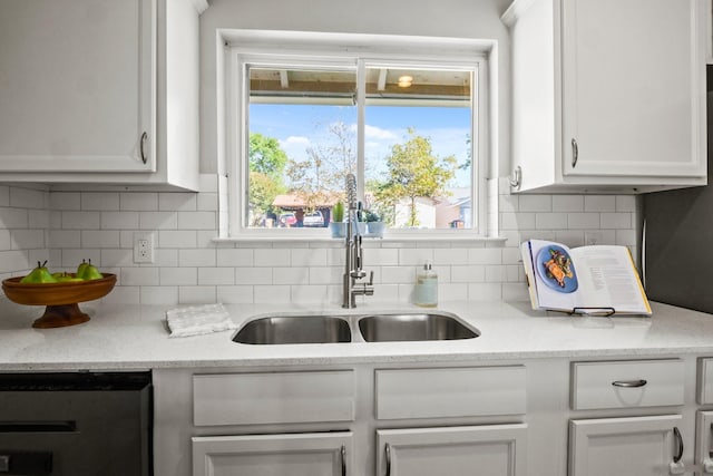 kitchen with sink, a wealth of natural light, and white cabinets