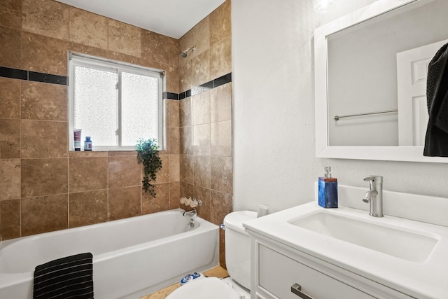 full bathroom featuring tiled shower / bath combo, vanity, and toilet