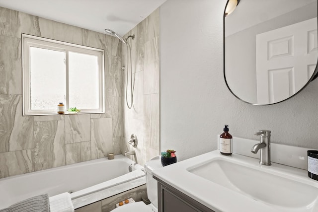 bathroom featuring vanity and tiled shower / bath