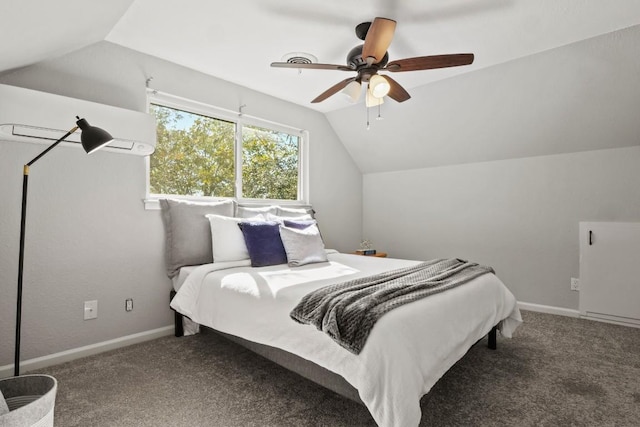 carpeted bedroom featuring vaulted ceiling, a wall unit AC, a ceiling fan, and baseboards