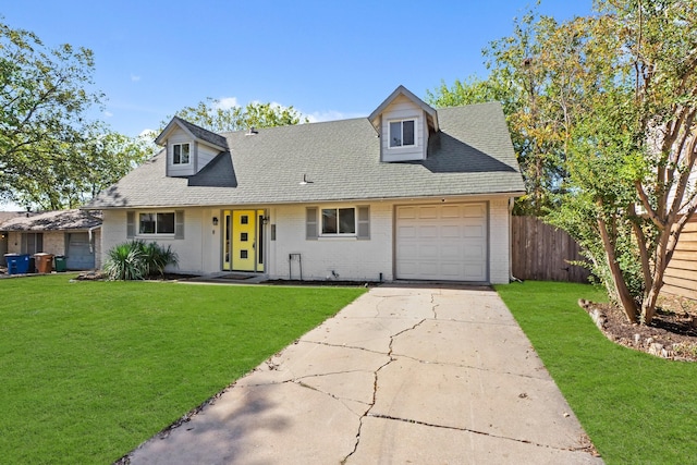 view of front facade with a garage and a front lawn