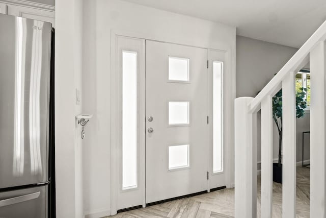 foyer entrance with light parquet flooring