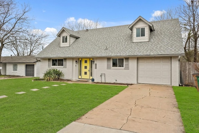 cape cod house featuring brick siding, concrete driveway, roof with shingles, an attached garage, and a front yard