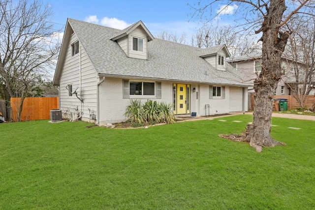 cape cod house featuring cooling unit, brick siding, fence, roof with shingles, and a front yard