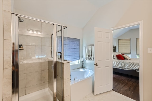 bathroom featuring shower with separate bathtub, lofted ceiling, and hardwood / wood-style flooring