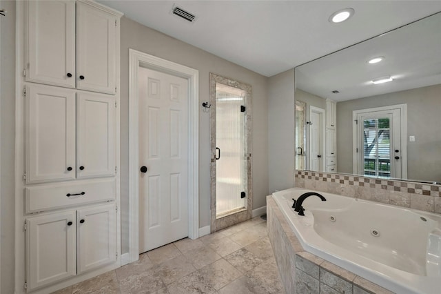 bathroom featuring separate shower and tub