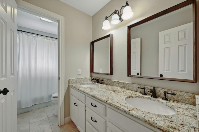 bathroom featuring tile patterned floors, vanity, and toilet