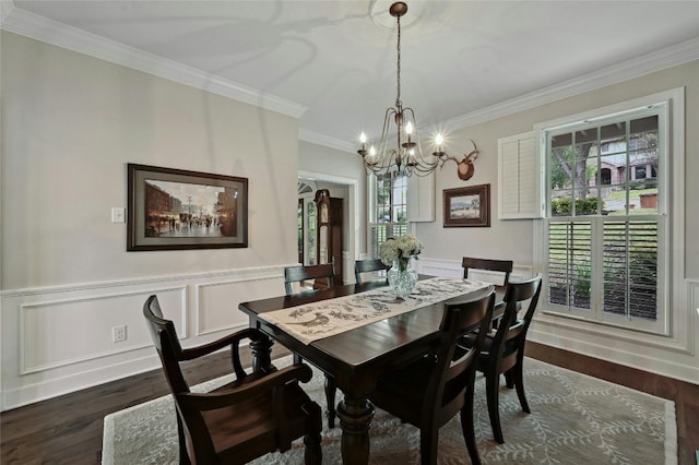 dining area with dark hardwood / wood-style flooring, an inviting chandelier, and crown molding