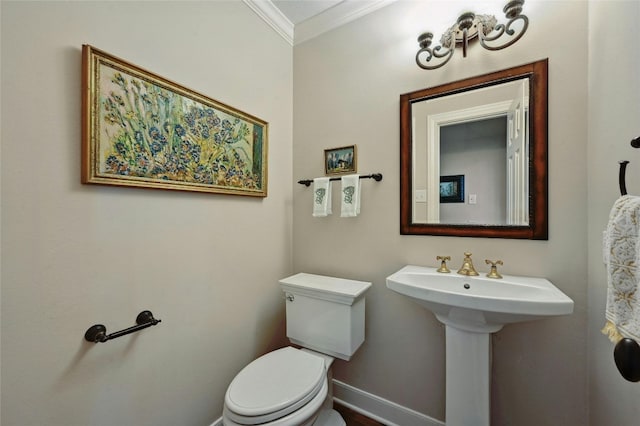 bathroom featuring sink, toilet, and crown molding