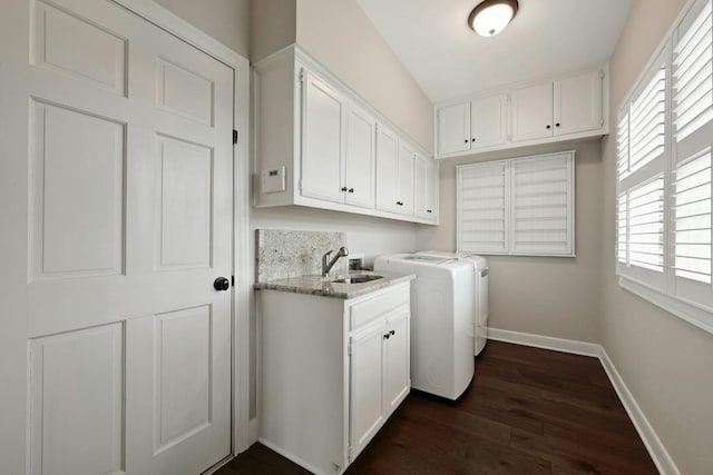 clothes washing area featuring washing machine and clothes dryer, cabinets, sink, and dark wood-type flooring