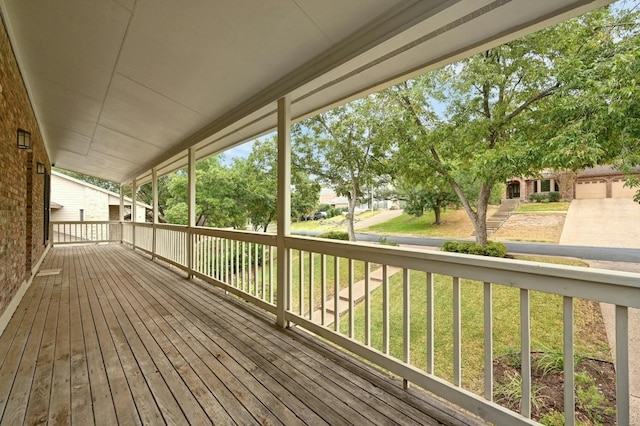 wooden deck featuring a yard and a porch