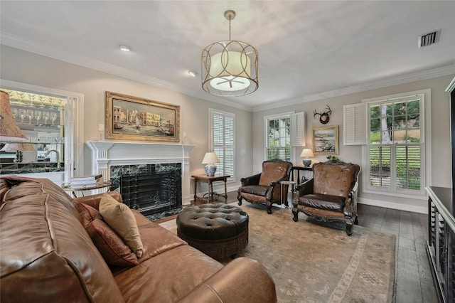 living room with ornamental molding, dark wood-type flooring, and a high end fireplace