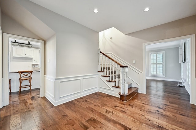 staircase with hardwood / wood-style flooring