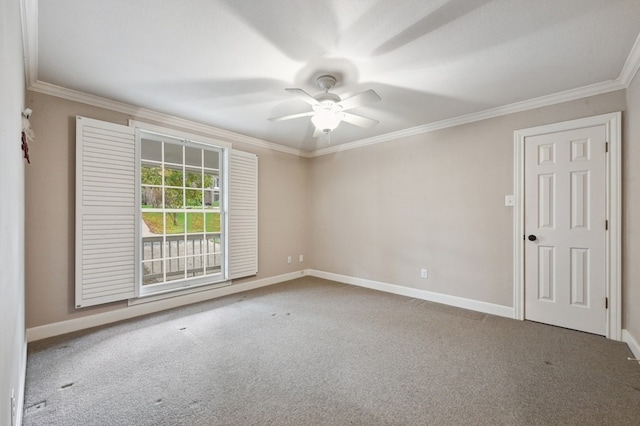 carpeted spare room featuring ceiling fan and crown molding