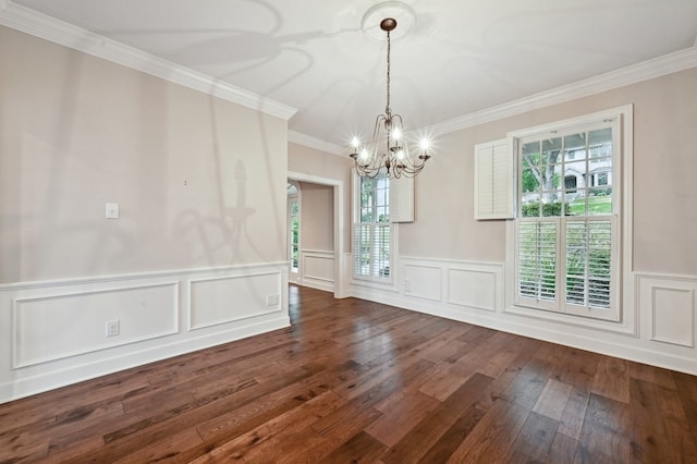 unfurnished dining area featuring crown molding, wood-type flooring, and a notable chandelier