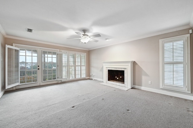 unfurnished living room with carpet, crown molding, and a tile fireplace