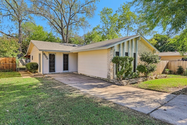 single story home featuring a front yard and a patio area