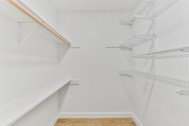 spacious closet with light wood finished floors