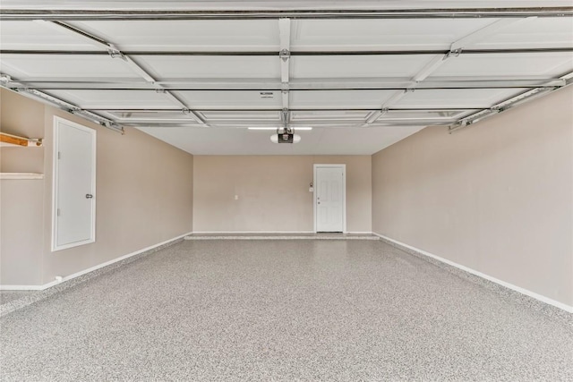garage featuring baseboards and a garage door opener