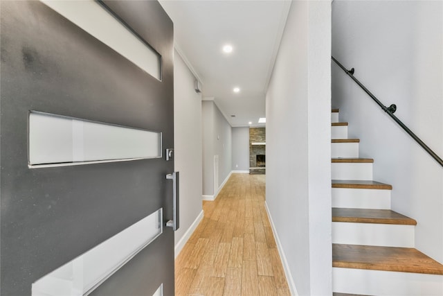 hallway with light hardwood / wood-style floors