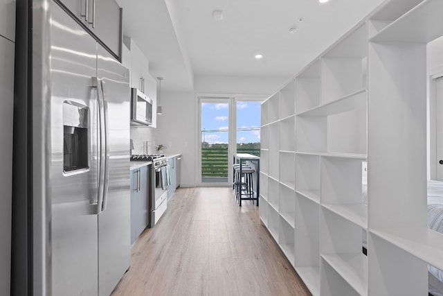 4004 Banister Ln Unit 301, Austin, TX 78704 - kitchen featuring appliances with stainless steel finishes, modern cabinets, light wood finished floors, light countertops, and recessed lighting