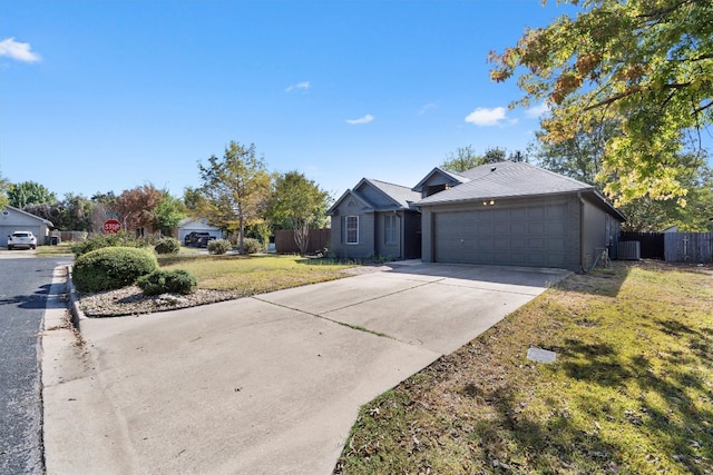 single story home with a garage, cooling unit, and a front yard