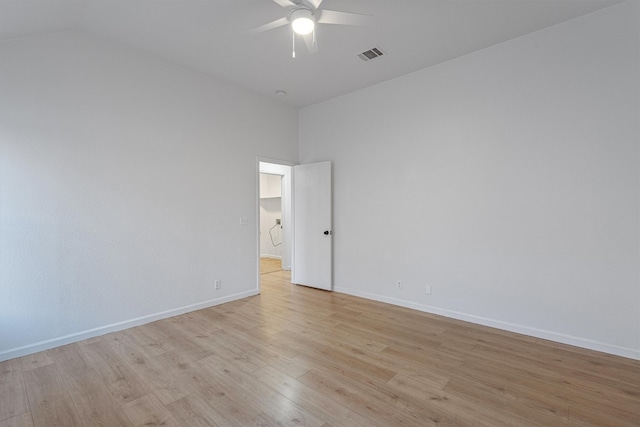 unfurnished room with ceiling fan, vaulted ceiling, and light hardwood / wood-style floors