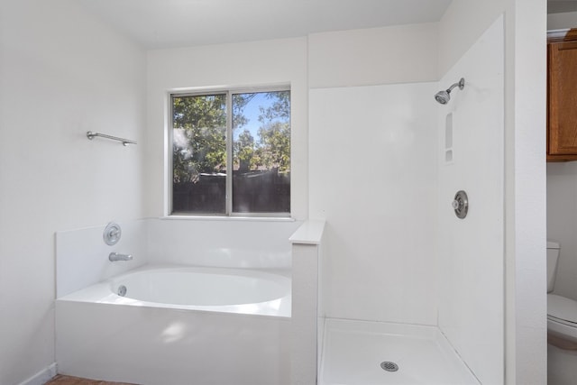 bathroom with toilet and plus walk in shower