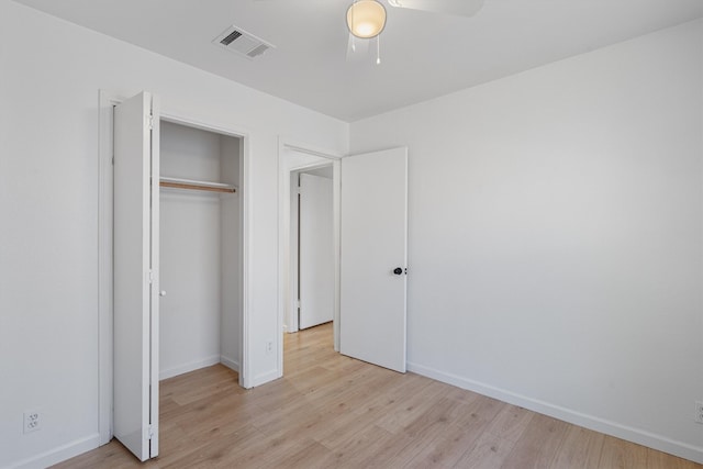 unfurnished bedroom featuring light hardwood / wood-style flooring, ceiling fan, and a closet