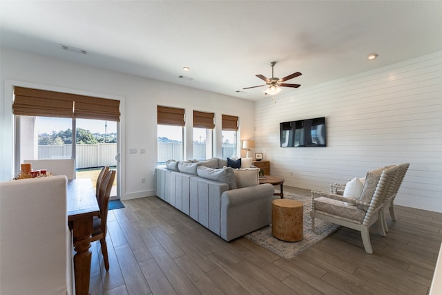 living room featuring a wealth of natural light, hardwood / wood-style flooring, and ceiling fan