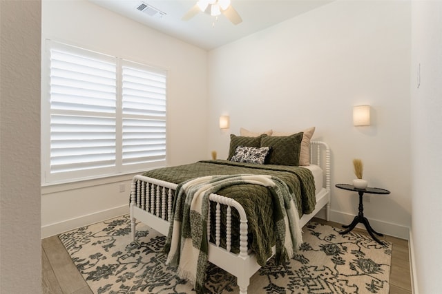 bedroom with light hardwood / wood-style floors and ceiling fan