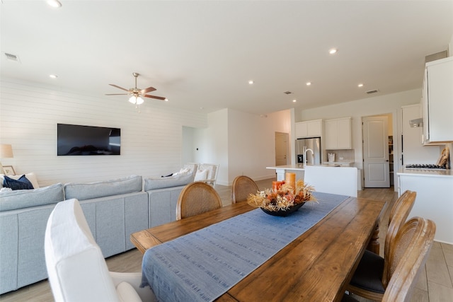 dining space featuring ceiling fan and light hardwood / wood-style flooring