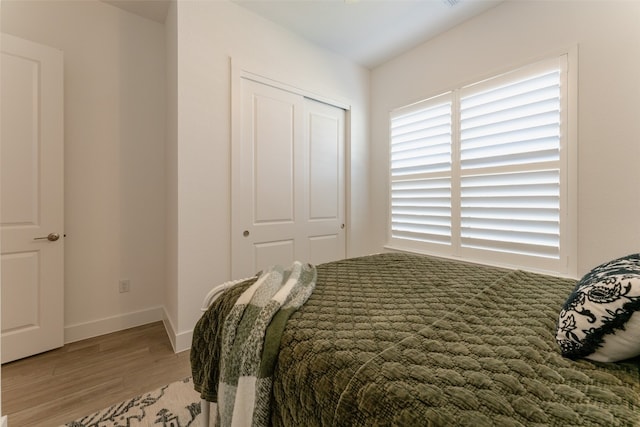 bedroom with hardwood / wood-style flooring and a closet