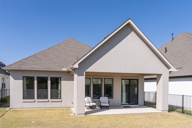 back of property featuring a patio and a yard