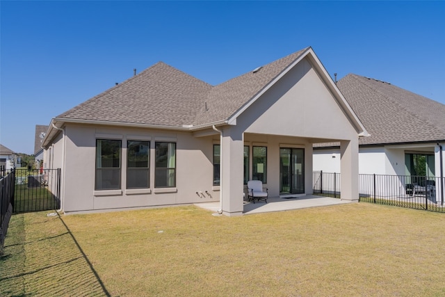 back of house featuring a lawn and a patio