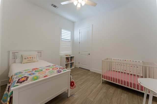 bedroom with wood-type flooring and ceiling fan