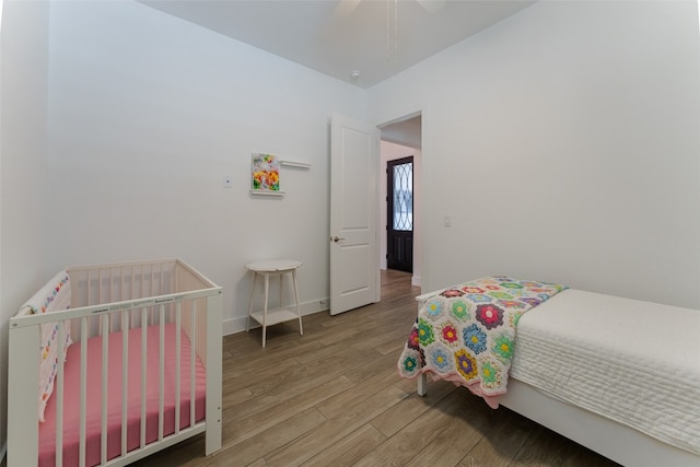 bedroom with light hardwood / wood-style floors and ceiling fan