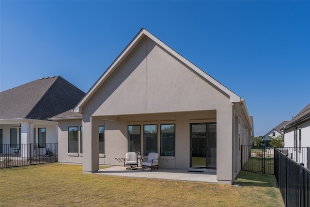 back of house with a yard and a patio area