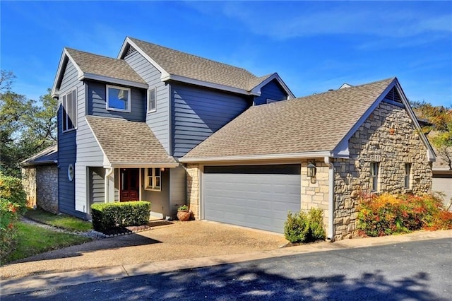 view of front of home featuring a garage, driveway, and roof with shingles