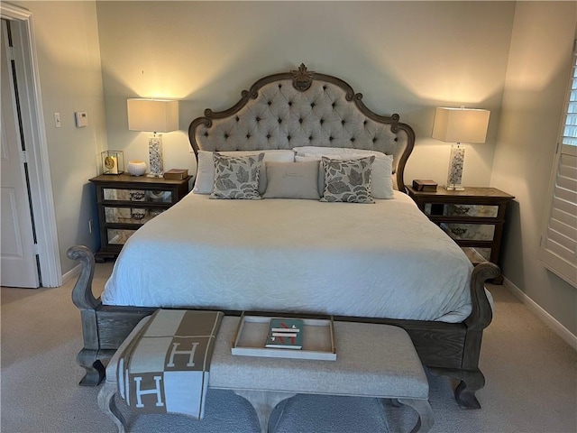 bedroom with carpet flooring and baseboards