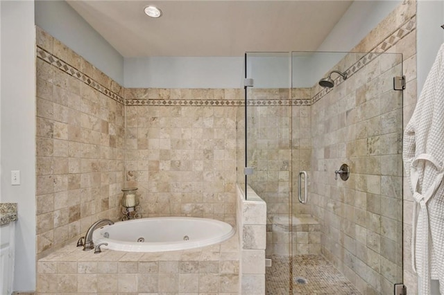 full bathroom with a shower stall and a tub with jets