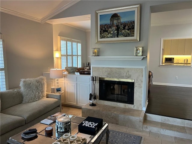 living area with lofted ceiling, baseboards, crown molding, and a high end fireplace