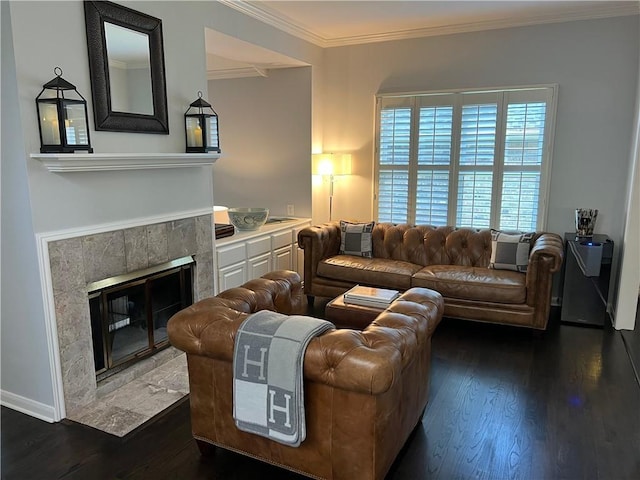 living room featuring dark wood-style flooring, crown molding, and a premium fireplace