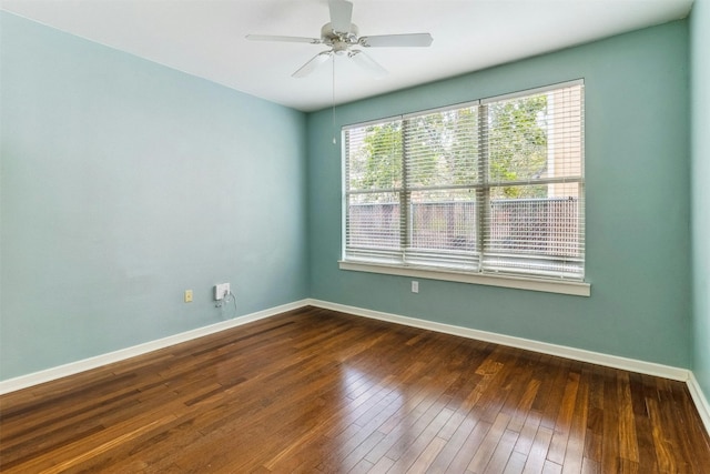 unfurnished room featuring dark wood-type flooring and ceiling fan