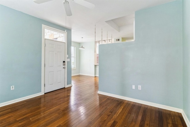 entryway with dark wood-type flooring and ceiling fan