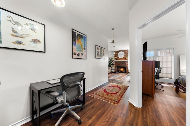 office space with a large fireplace and dark hardwood / wood-style floors