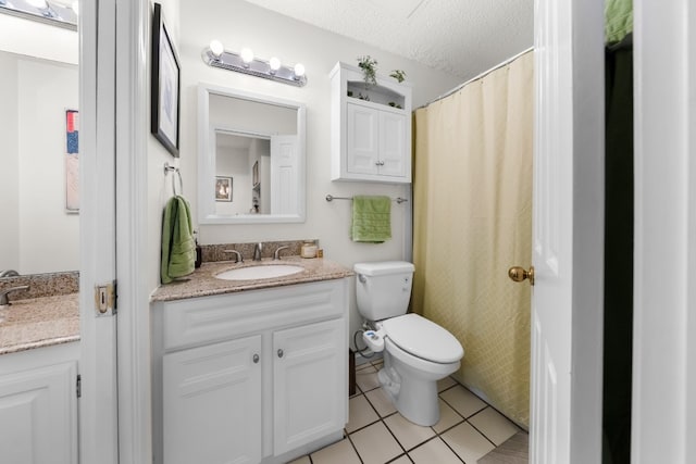 bathroom with vanity, tile patterned floors, toilet, and a textured ceiling