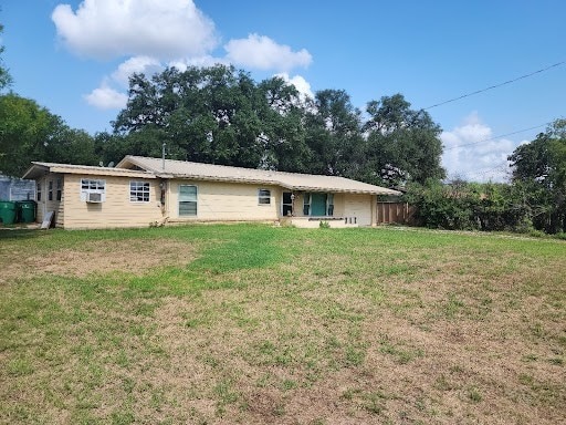 back of property featuring a lawn