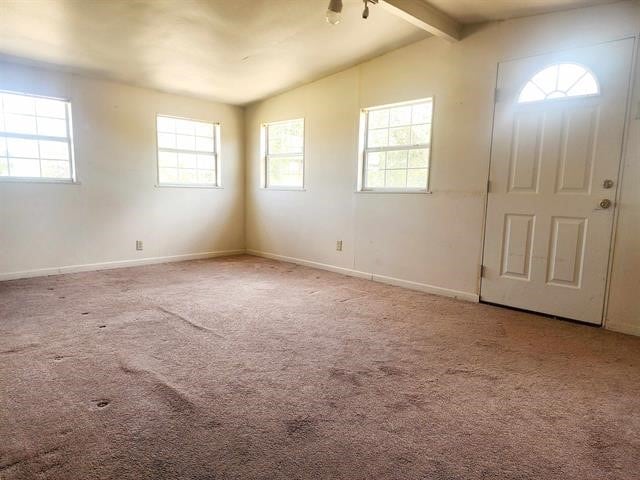 carpeted foyer featuring vaulted ceiling with beams and ceiling fan